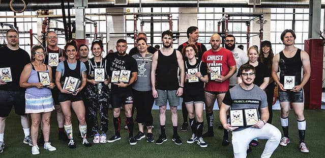 Competitors line up together holding their plaques at the end of an APA meet.
