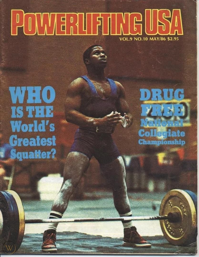 Powerlifting USA cover from May 1986: a lifter in a blue singlet stands over a loaded bar with freshly chalked hands.